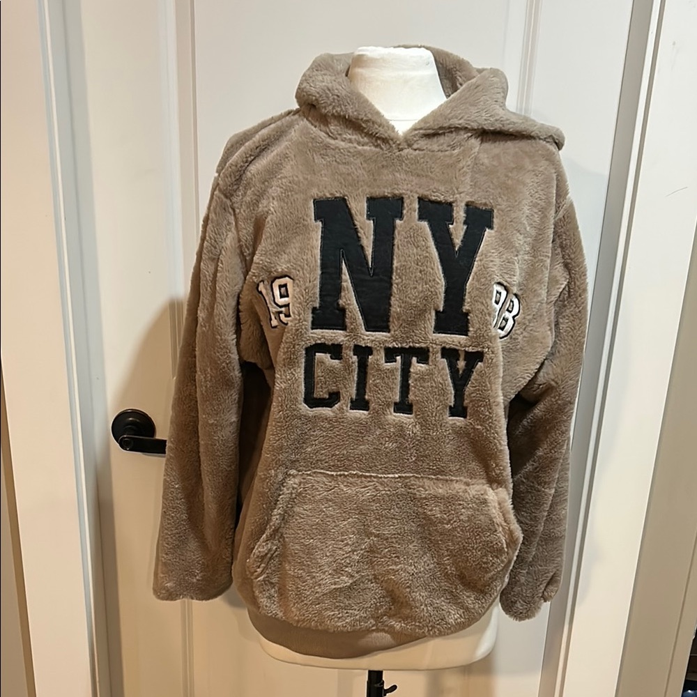 Taupe NY faux fur City Pullover Hoodie. Logo says NY City 1998